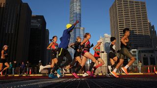 Marathon runners head down Columbus Drive in the early sunlight as the Bank of America Chicago Marathon starts on Oct. 9, 2022
