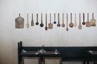 Dining area with rustic kitchen appliances hanging on the wall at Rooms Hotel Kokhta
