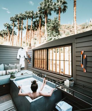 woman sitting in an outdoor spa