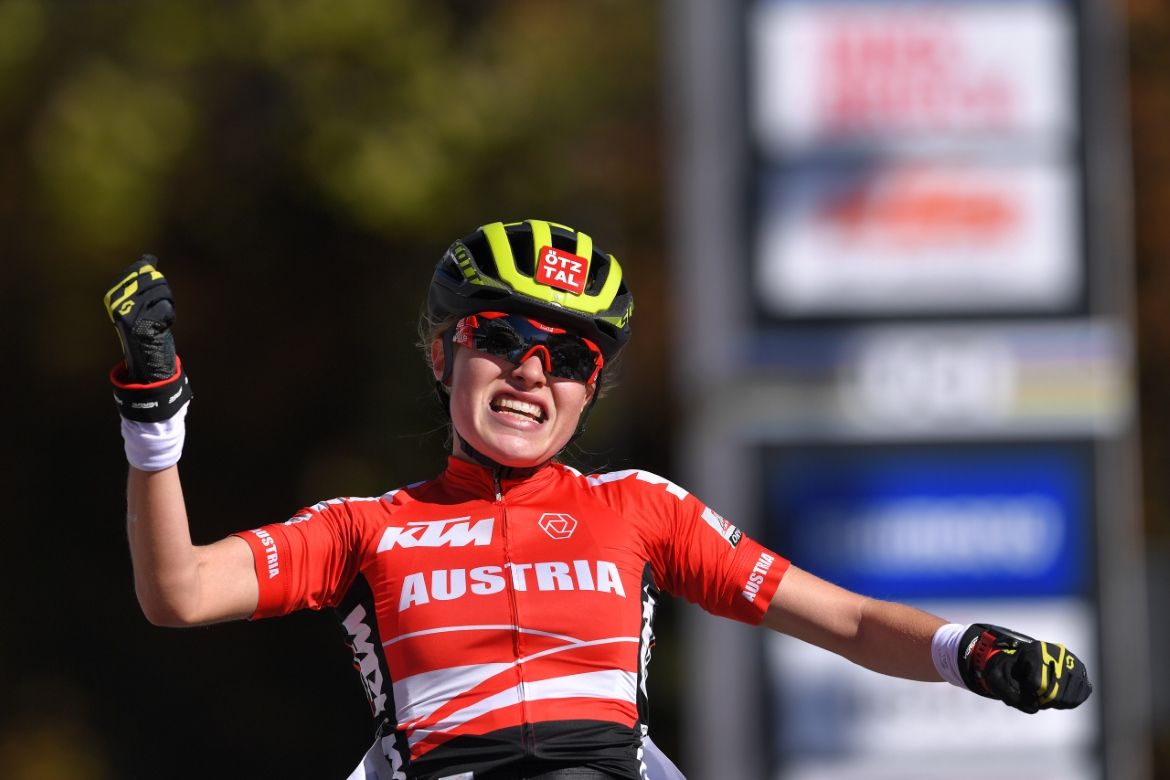 Laura Stigger raises her arms in celebration