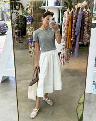 Fashion editor Judith Jones wears white skirt and gray shirt.