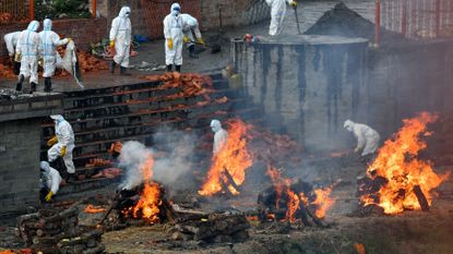 Crematorium workers wearing PPE in Kathmandu, Nepal