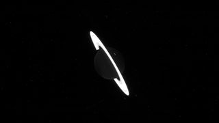 Saturn is pitch black, with only its glowing rings visible, in this raw James Webb telescope image