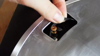 Hand pulling through a rubber belt and fitting it to a turntable pulley