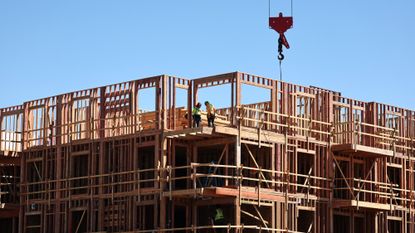 Workers build an apartment complex in Los Angeles