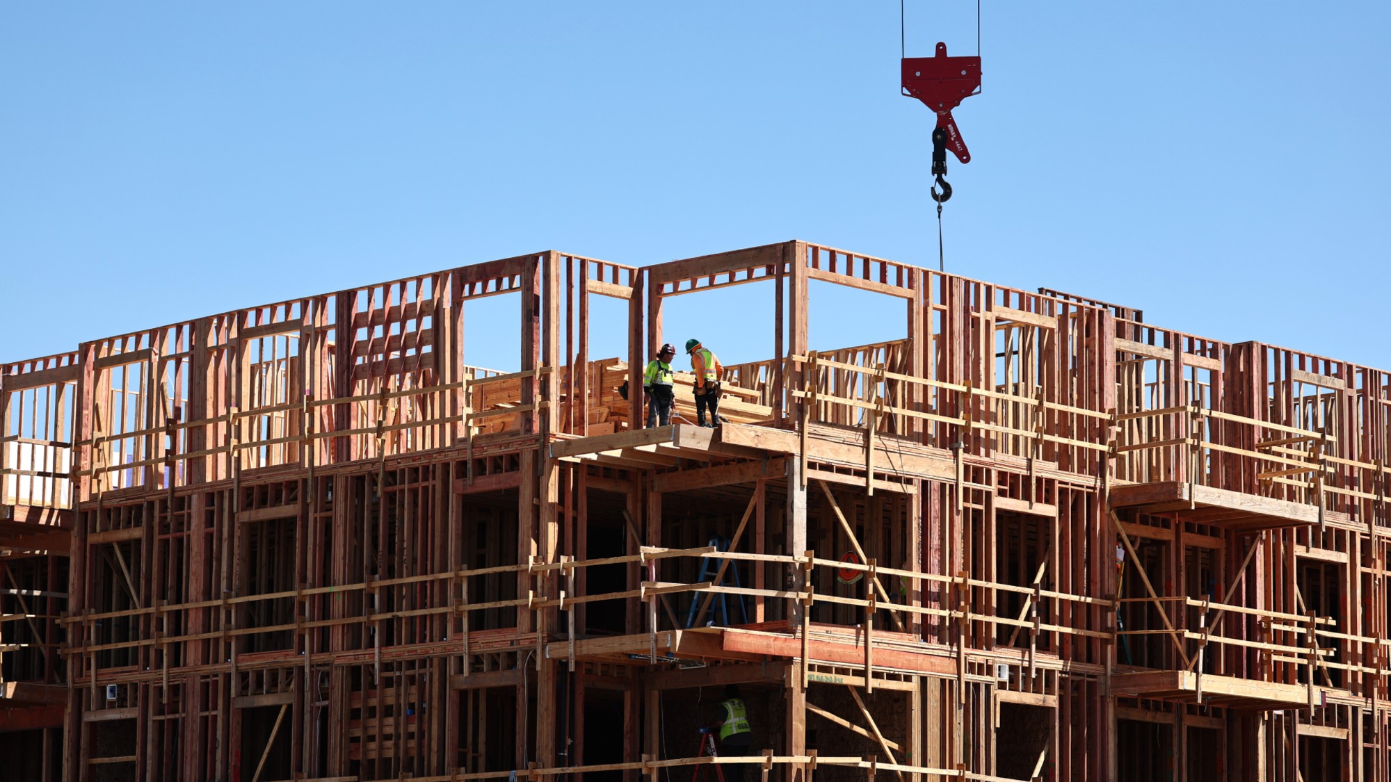 Workers build an apartment complex in Los Angeles