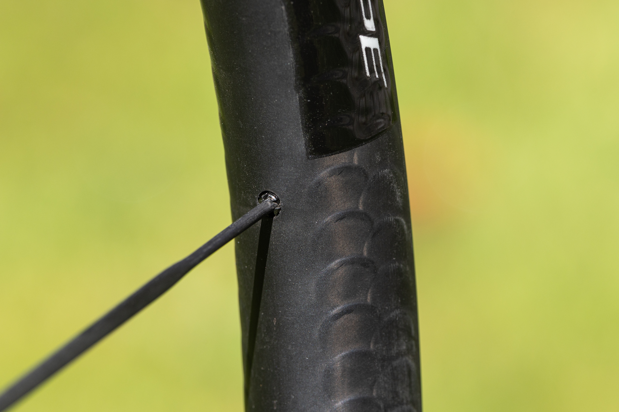 close up of a black carbon rim showing the fish scale pattern
