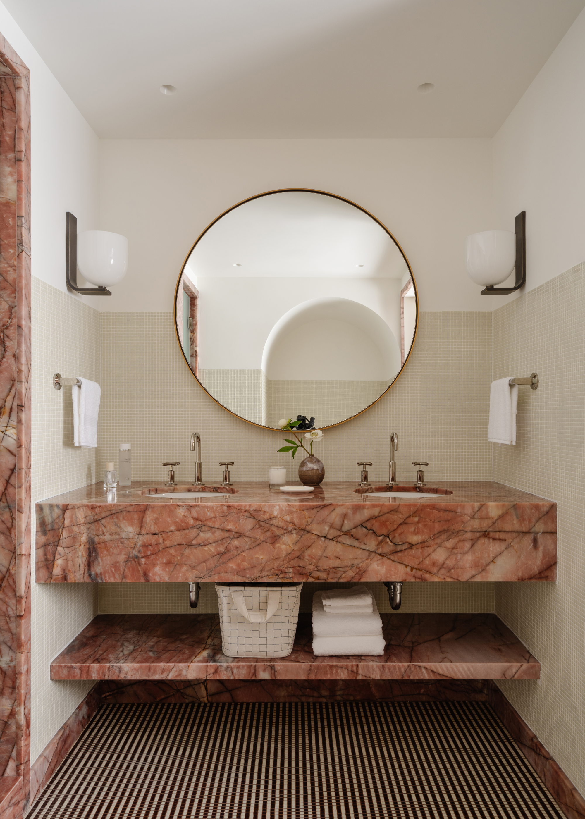 a bathroom double vanity in a dramatic pink stone