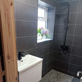 bathroom with black wall tiles