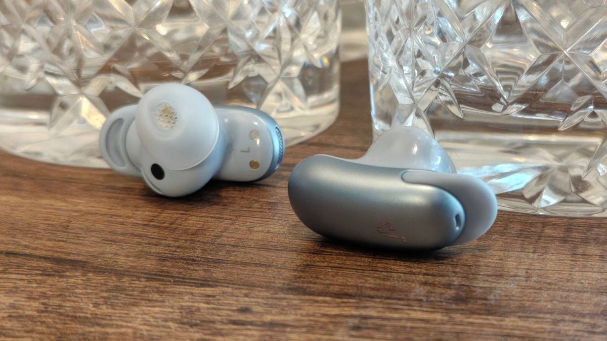 The Anker Soundcore Liberty 5 Pro on a shelf, next to some glasses.