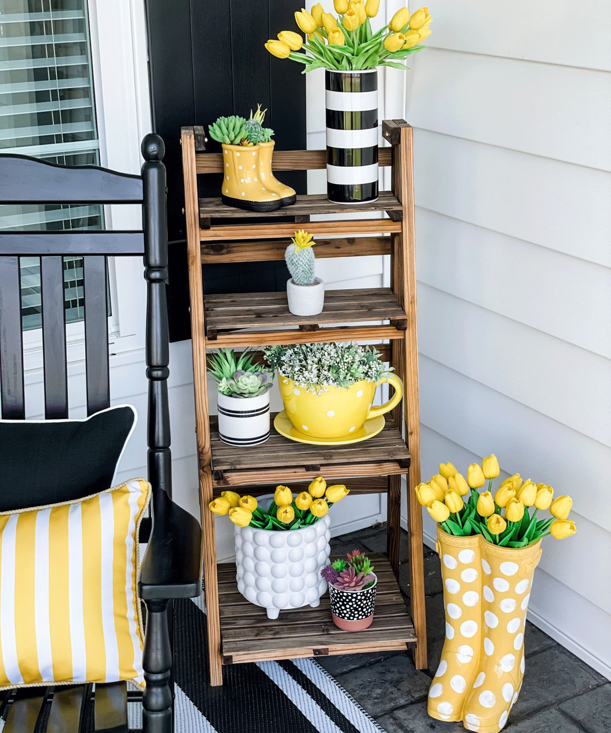 Yellow decor styled on rustic wooden ladder on porch.