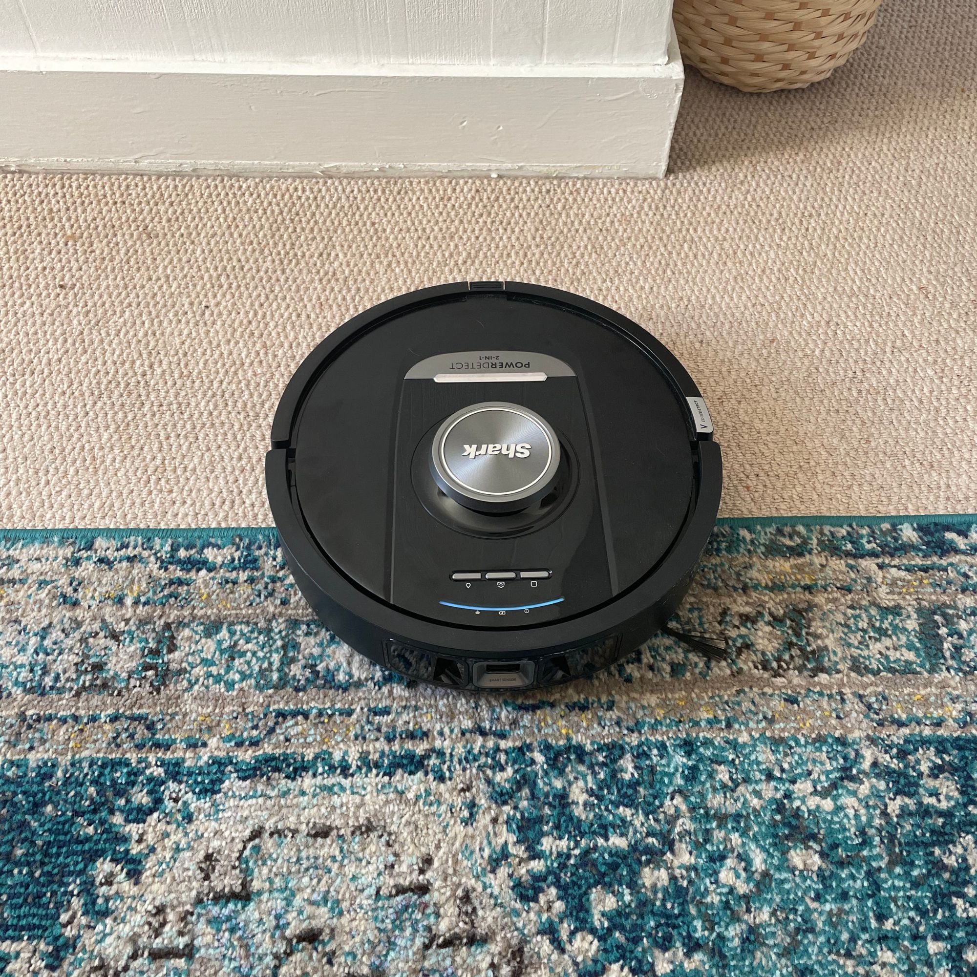 Shark PowerDetect NeverTouch Robot Vacuum on carpet and rug in bedroom