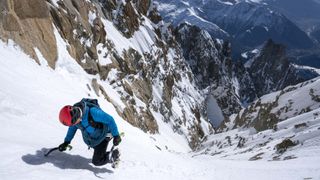 how to use an ice axe: climber daggering up a slope