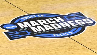 The NCAA March Madness logo on a basketball court