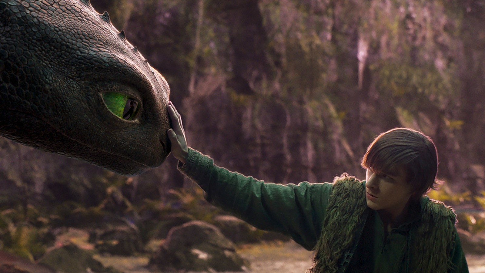 Mason Thames as Hiccup petting Toothless the dragon in How to Train Your Dragon