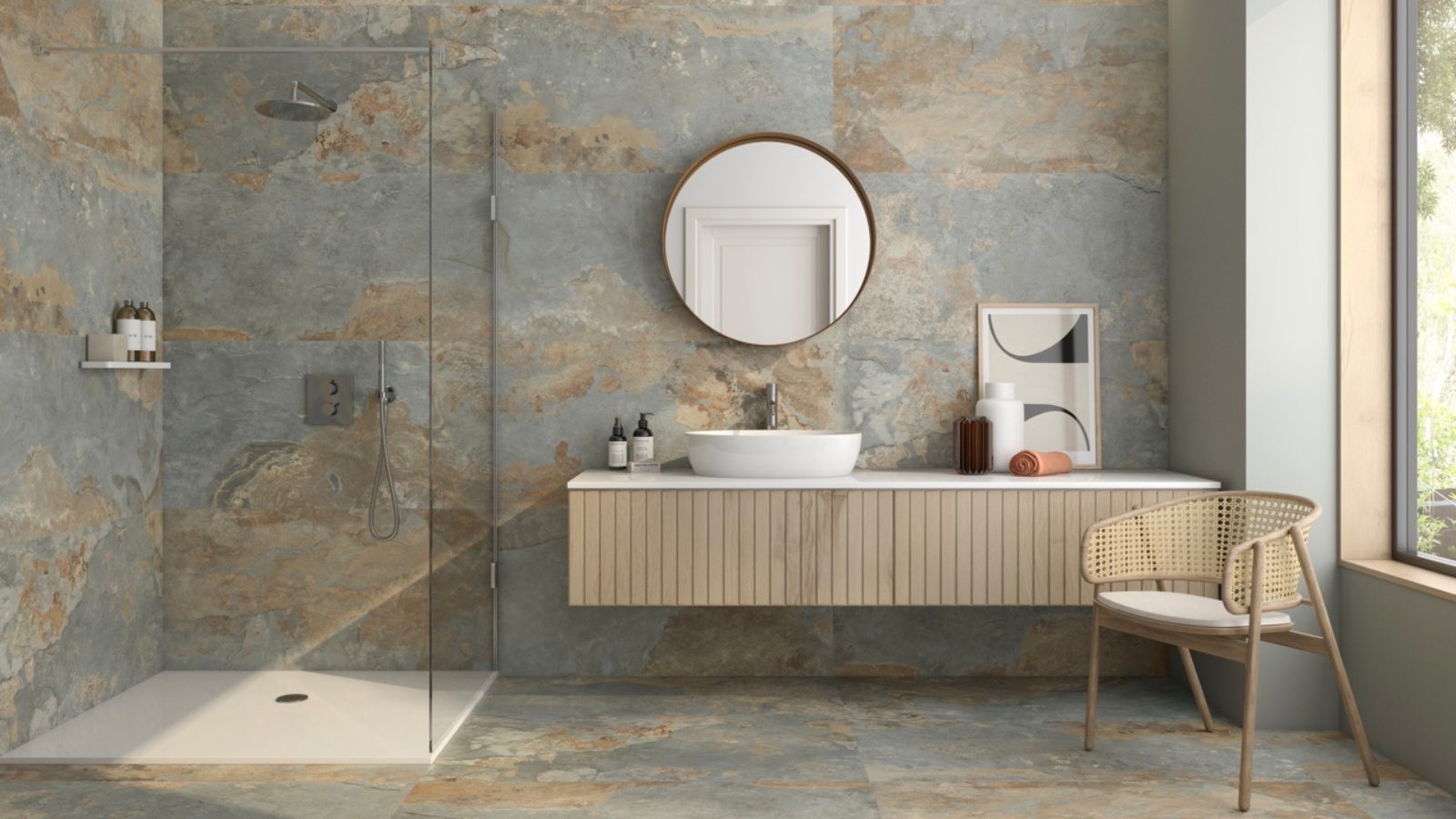 grey bathroom with grey stone large format tiles, wall mounted wooden vanity and walk in shower
