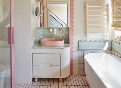 A white bathroom with pink accents