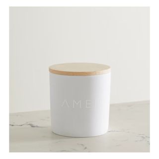 scented candle in white ceramic vessel