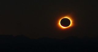 Photo of 2010’s total solar eclipse setting behind the Andes mountains. 