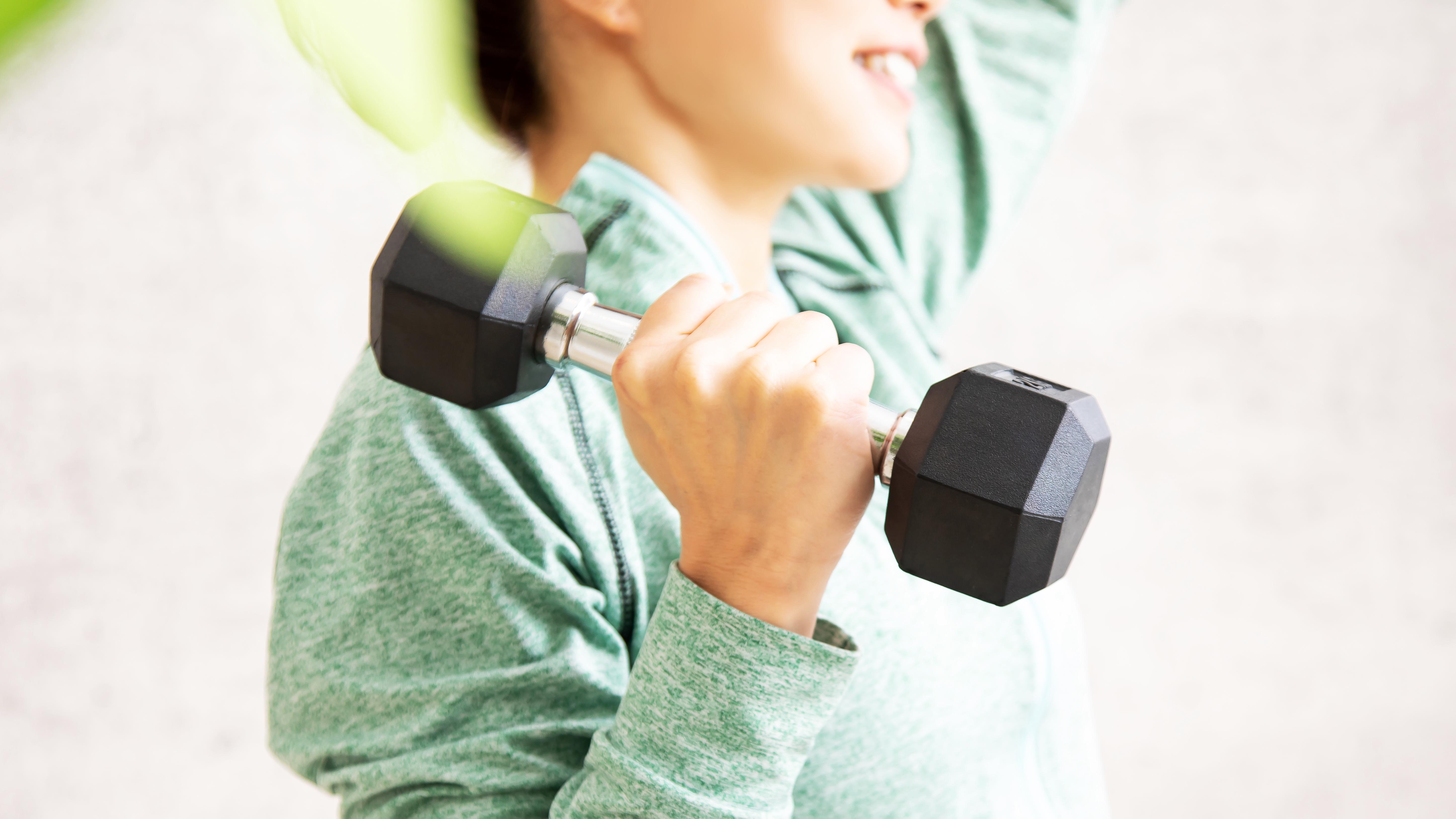 a woman holding a dumbbell