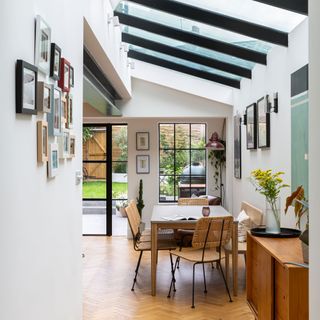 view into a kitchen diner with a large skylight above