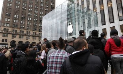 People swarm around the Apple flagship store in New York before the iPad 2's release last March