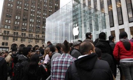 People swarm around the Apple flagship store in New York before the iPad 2&amp;#039;s release last March