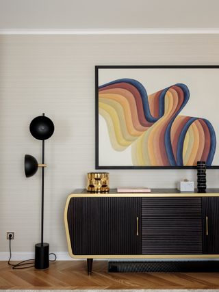 A living room corner with an art piece