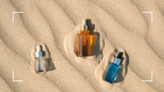 A selection of the best body oil pictured in the sand 