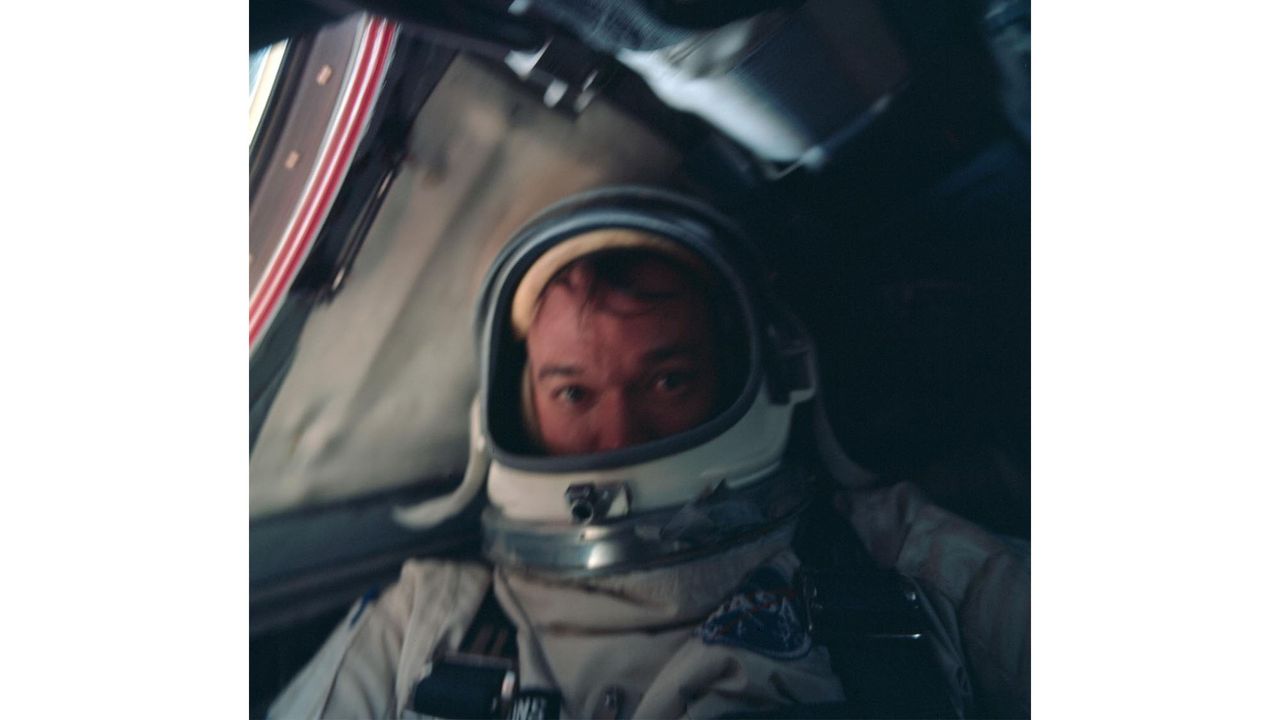 Astronaut Michael Collins is in a spacesuit inside of a spacecraft during NASA's Gemini 10 mission.