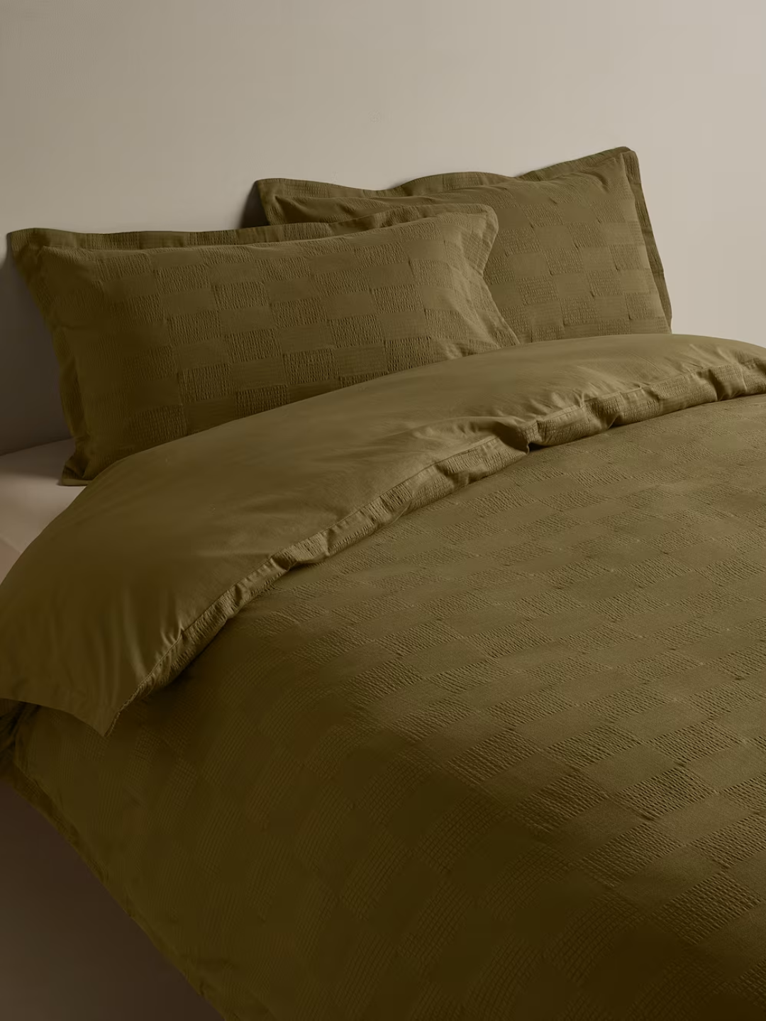 An olive green sateen seersucker checkerboard bedding set from M&amp;amp;S