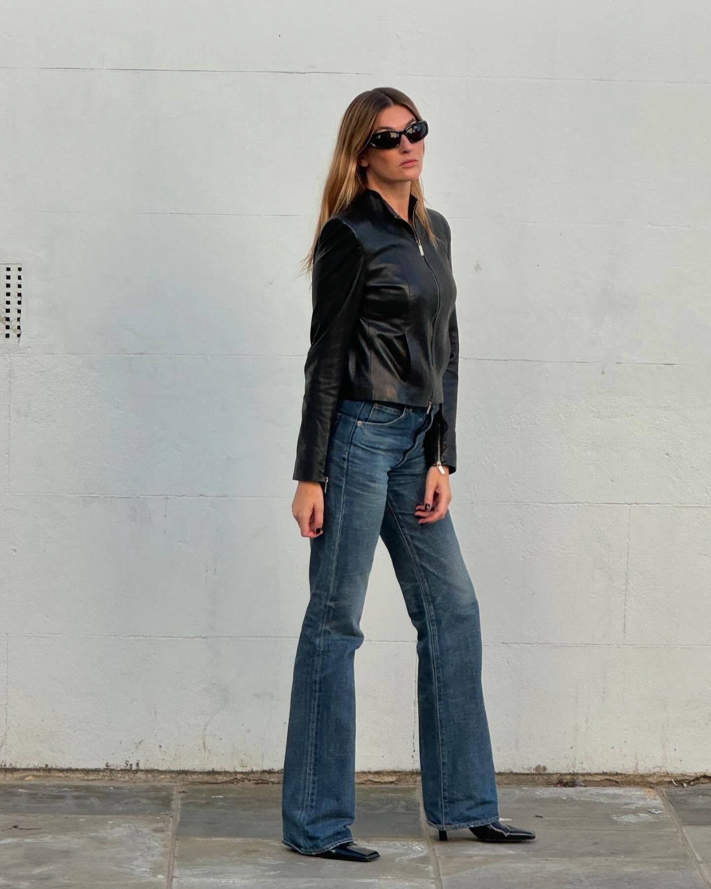 Fashion person Camille Charriere wears a fitted leather jacket, blue jeans and black boots in a recent image taken from her Instagram