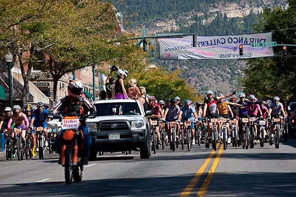 Durango local and 2006 Single speed World Champion, Travis Brown, is at the head of affairs in the neutral parade start down Main Street.