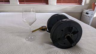 Bear Original mattress with a weight, wine glass and tape measure to show motion transfer test