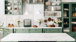 green country kitchen with open shelving, and a wide stone island in front
