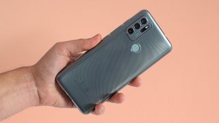 A Moto G60S from the back, in someone's hand