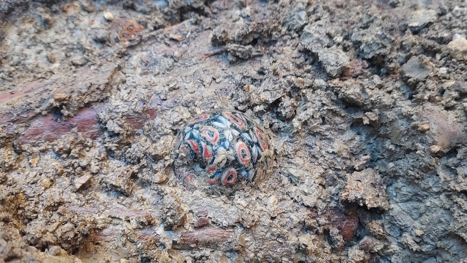A large millefiori glass bead speckled with different colors of glass that were fused together found at the burial site.