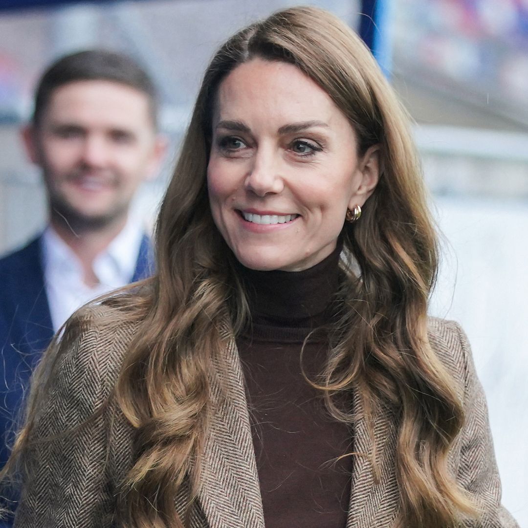 Princess Kate wearing a brown turtleneck and smiling
