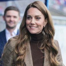 Princess Kate wearing a brown turtleneck and smiling