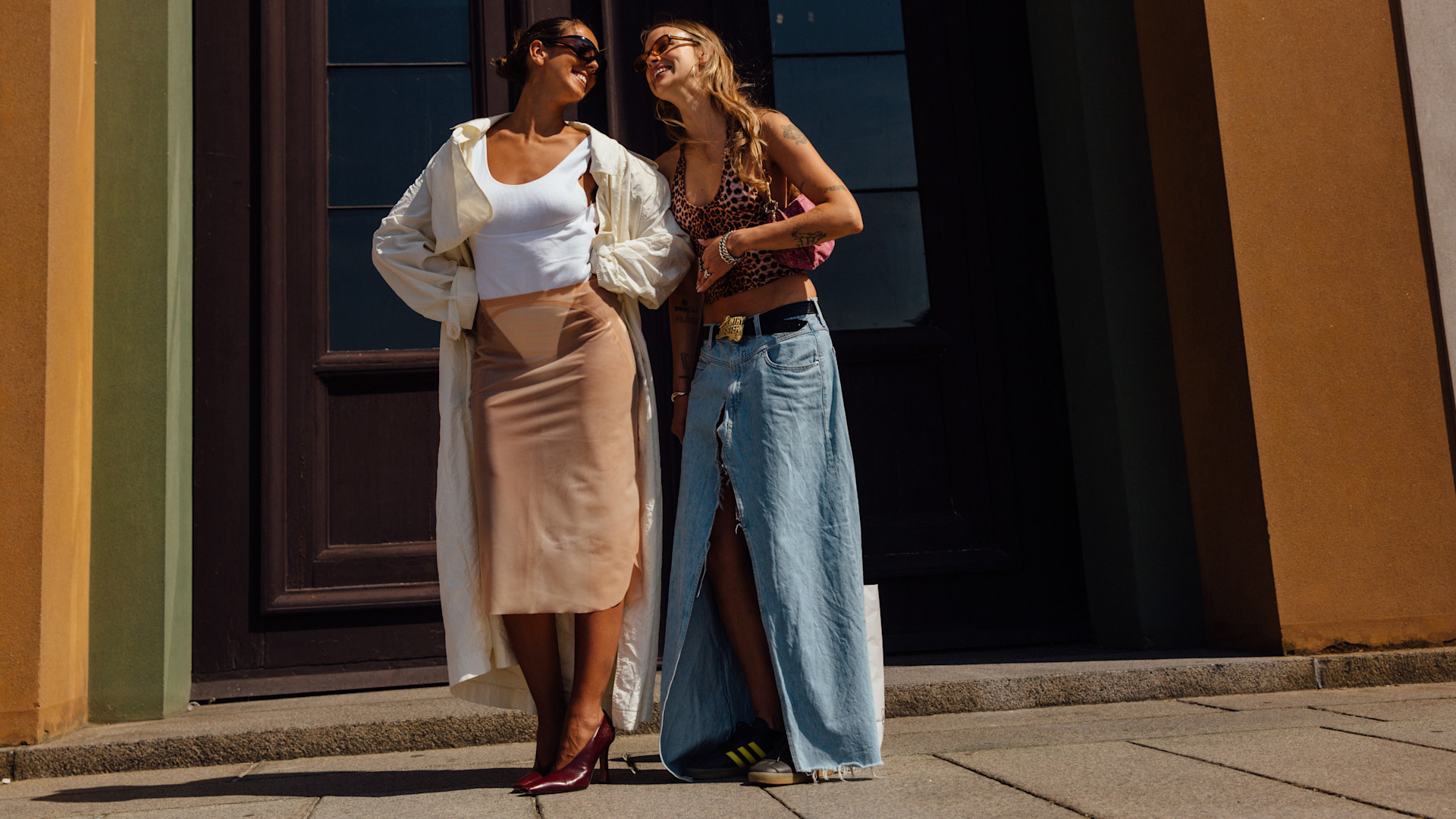 two fashion week attendees smiling at each other
