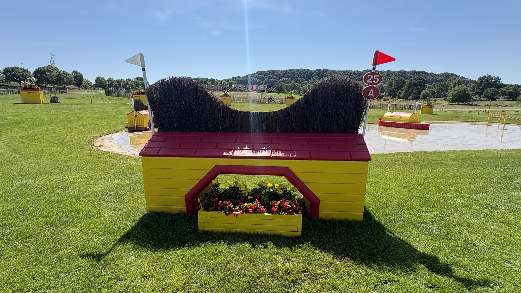 A yellow and red fence into water on the eventing World Championships cross-country course