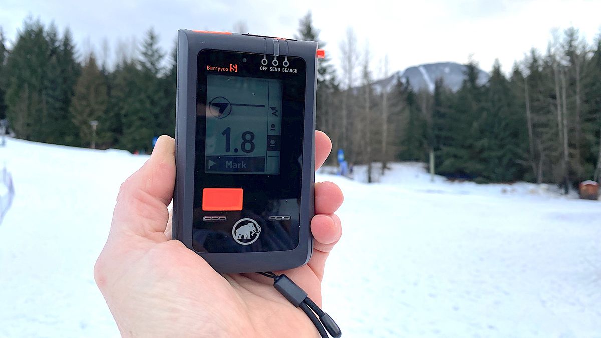 Person holding Mammut Barryvox S avalanche beacon