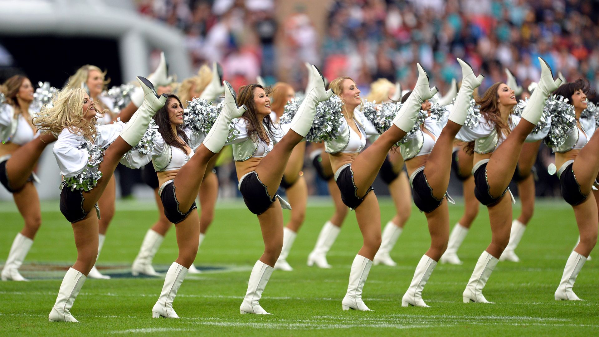 The Oakland Raiders Raiderettes perform at the NFL football match between Oakland Raiders v Miami Dolphins at Wembley Stadium