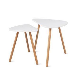 Two white curved coffee tables with wooden legs