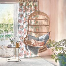 Living room with hanging bamboo chair and plants