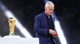 France coach Didier Deschamps walks past the trophy after World Cup final defeat to Argentina.