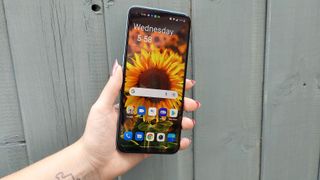 OnePlus Nord CE 2 Lite review: phone screen with a sunflower up against a blue wall