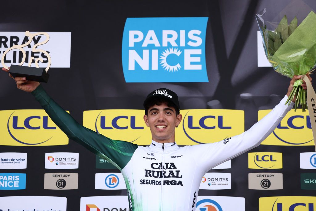 Caja Rural-Seguros RGA's Spanish rider Samuel Fernandez Garcia celebrates on the podium with the combativity award after the 1st stage of the Paris-Nice cycling race, 156,1 km between Le Perray-en-Yvelines and Le Perray-en-Yvelines, on March 9, 2025. (Photo by Anne-Christine POUJOULAT / AFP)