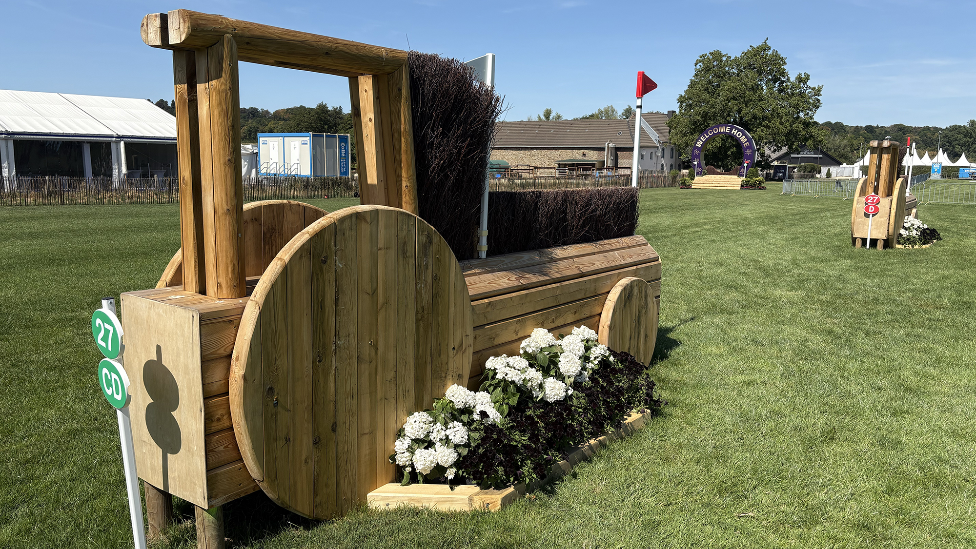 An angled brush fences shaped like a tractor on the eventing World Championships cross-country course