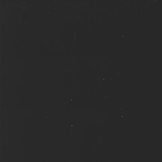 a nearly all black image, with a half dozen faint points of light scattered about